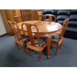 A Chinese style hardwood dining table with leaf and six chairs