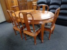 A Chinese style hardwood dining table with leaf and six chairs