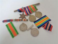 A Group of three WW II medals on bar together with two further medals of the same war.