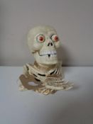 A cast iron skeleton money box