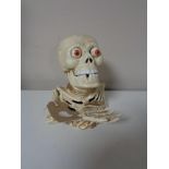 A cast iron skeleton money box