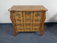 An oak four drawer serpentine fronted chest