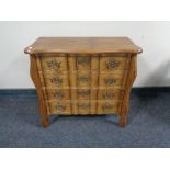 An oak four drawer serpentine fronted chest