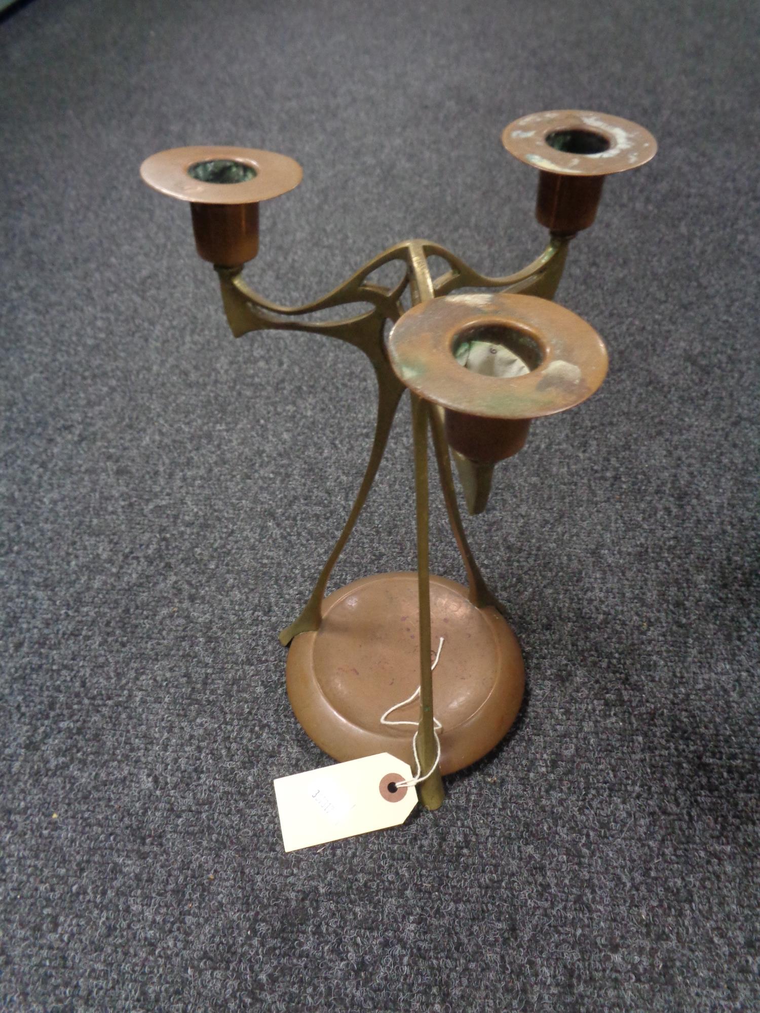 An elegant copper and brass Art Nouveau candelabra, hand signed and dated December 1893.