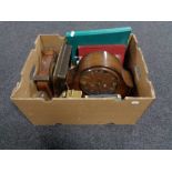 A box of assorted clocks, Hillman workshop manual, miniature pyramid tripod,