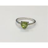 A silver peridot dress ring,