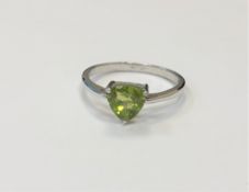 A silver peridot dress ring,