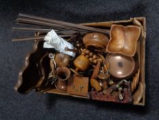 A box containing wooden items; nut bowls, pipe rack, comport,