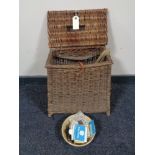 An early 20th century wicker fisherman's stool basket with canvas and leather straps,