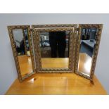 A decorative gilt framed dressing table mirror