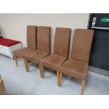 A set of four brown suede dining chairs