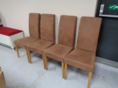 A set of four brown suede dining chairs