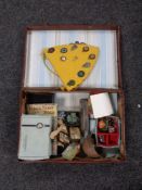 A vintage leather case containing miscellany to include costume jewellery, harmonica, treen barrel,