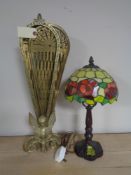 A brass peacock fire screen together with a Tiffany style table lamp