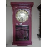 An early twentieth century painted wall clock with silvered dial,