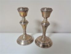 A pair of small silver candlesticks, height 14 cm.