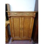 An early 20th century double door cabinet fitted a drawer