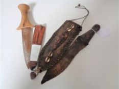 Two African knives, one with carved 'head' terminal.
