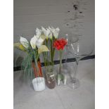 A quantity of glass vases with artificial flowers