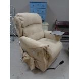 An electric reclining armchair in beige fabric