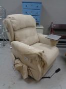 An electric reclining armchair in beige fabric