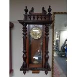 An early 20th century Junghans eight day wall clock with pendulum and key