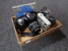 A box of cameras to include Minolta Dynax 500SI with lens, Nikon Coolpix 995,