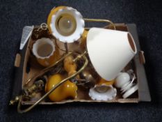 A box of brass light fittings with glass shades