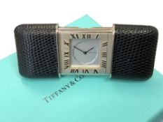 A Purse/Travel Alarm Watch by Tiffany & Co, quartz battery movement, silvered dial signed,