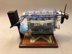 A plastic model of a combustion engine, on plinth, height 22cm.