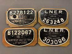 Four cast iron railway wagon plates;