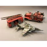 Two tin plate models of fire engines and another of a fighter jet.