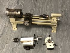 A workshop lathe, together with two other components.