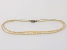 A 14 inch double strand of pearls on silver marcasite clasp