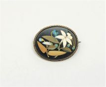 An oval pietra dura brooch in gold frame