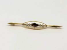 An antique gold garnet and diamond brooch