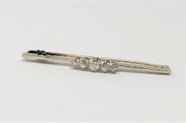 An 18ct gold and platinum five stone diamond brooch, approximately 0.9ct, 5.2g.