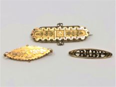 An antique gold 'baby' brooch together with two further similar brooches, 6.35g.