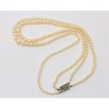 A good double strand of pearls on gold and diamond clasp CONDITION REPORT: Pearls