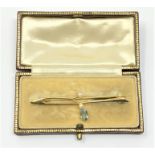 An Art Nouveau yellow gold (tested 15ct) and aquamarine brooch, 3.4g, boxed.