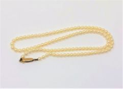 A 16 inch strand of pearls on a yellow gold clasp