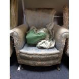 A Victorian horse hair filled armchair in floral brocade fabric