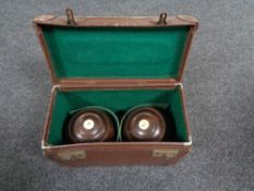 A pair of vintage wooden lawn bowls in case.
