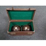 A pair of vintage wooden lawn bowls in case.