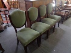 Four 20th century dining chairs in green corded fabric