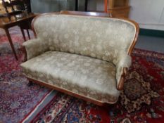A mahogany framed settee in floral fabric