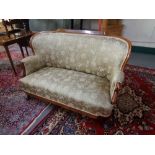 A mahogany framed settee in floral fabric