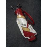 A Max Fly golf bag containing irons, drivers and putters.