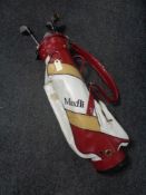 A Max Fly golf bag containing irons, drivers and putters.