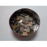 A tin of pre decimal British and foreign coins.